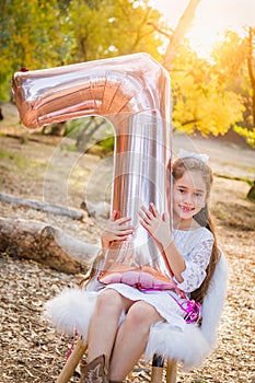 Sweet Young Girl With Number Seven Mylar Balloon Outdoors