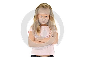 Sweet young schoolgirl with blond hair and folded arms angry upset frustrated and unhappy