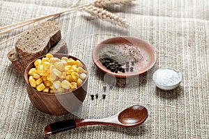 Sweetcorn in wooden bowl on canvas background
