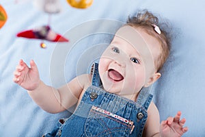 Sweetest baby girl playing with a colorful mobile toy