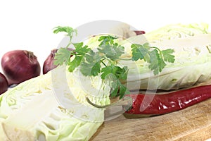 Sweetheart Cabbage with hot peppers on a board