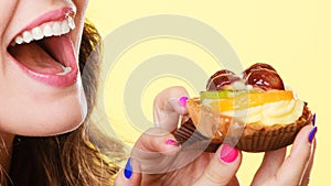 Closeup woman eating fruit cake sweet food