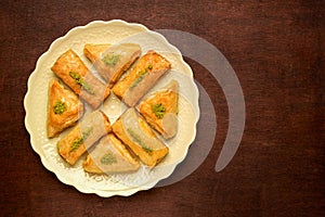 Sweets arabic dessert baklava, , kunafa, kadayif with pistachio nuts and cheese . Top view, copy space