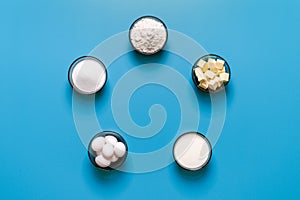 Sweets baking ingredients top view, isolated on a blue background