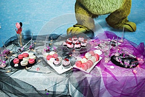 Sweets candy bar, cupcakes cakes on table