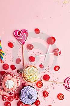 Sweets. Candy And Cupcakes On Pink Background