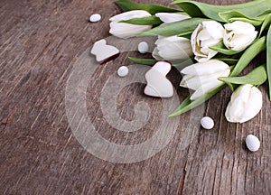 Sweets for celebrate Easter. White tulips, chocolate eggs and bunny