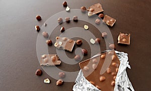 Milk chocolate bar with hazelnuts in foil wrapper