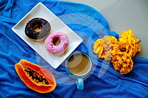 Sweets donuts With A Cup Of Coffee And Fruits