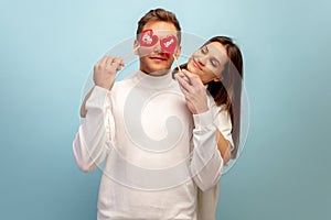 Beautiful couple in love on blue studio background. Valentine& x27;s Day, love and emotions concept