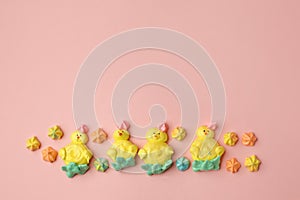 Sweets, pastry, gingerbread cookies for Easter table. Easter chiken on pink background top view copy space, spring seasonal