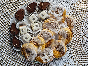 Sweets on a table decorated with lace napkin