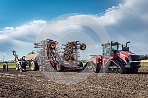 Swift Current, SK/Canada- May 15, 2020: Farmers consulting after loading seed and fertilizer into Bourgault air seeder in Sask