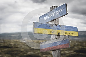 swift off text quote on wooden signpost outdoors on nato colored flag, ukrainian flag and russian flags