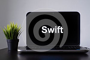 Swift programming language. Programming training, the concept of computer courses. Laptop on the table