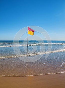 Swim between the flags on a sunny Australian beach