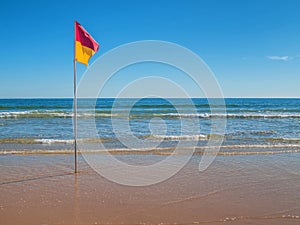 Swim between the flags on a sunny beach