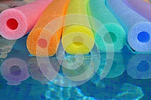 Swim floats in swimming pool, rainbow colours