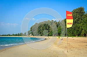 Swim here flag or safety flag on the beach for inform the tourist