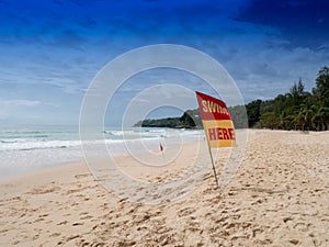 Swim here. Safety warning signs for tourists. At Surin beach mon