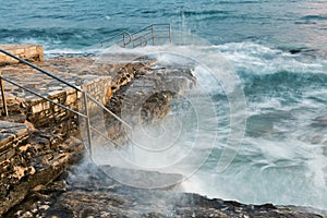 Swim ladder leading to stormy mystic sea