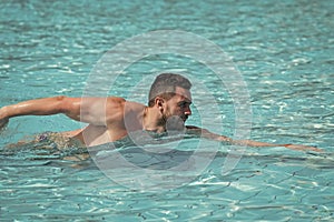 Swiming in the sea. Man or young swimmer swimming in pool with blue water