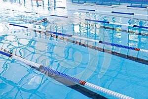 Swimmer in action at a competitive pool event, with copy space