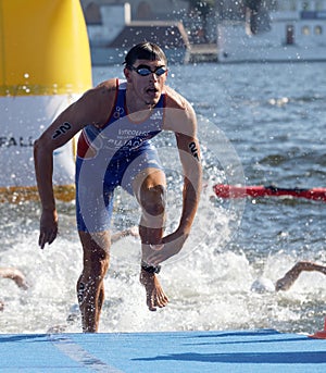 Swimmer Anthony Pujades (FRA) climbing up from the water