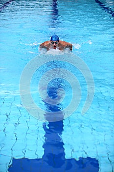 Swimmer in blue swimming pool