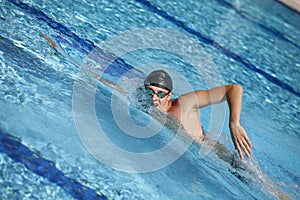 Swimmer in cap breathing during front crawl