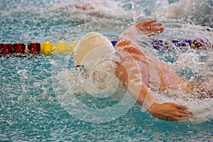 Swimmer Does Butterfly Stroke in a Pool