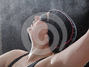 Swimmer with glasses swims on her back