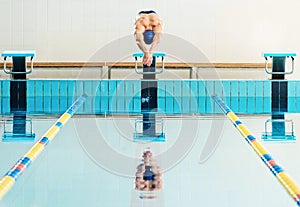 Swimmer jumping from starting block