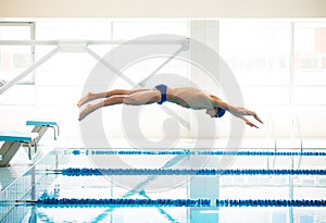 Swimmer jumping from starting block