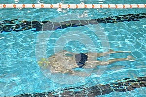 Swimmer, man swimming underwater in a pool photo