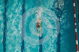 Swimmer in motion in pool lane