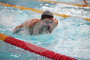 Swimmer in motion in a spray of water