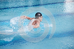 Swimmer performing the butterfly stroke,profile