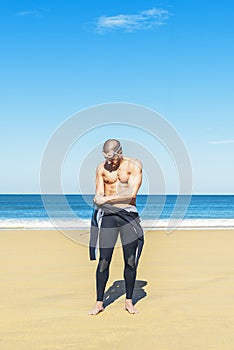 Swimmer putting on his wetsuit.