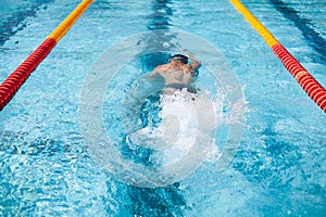 Swimmer splash after diving in the pool during contest