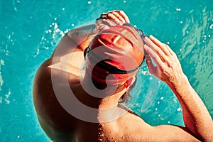 swimmer standing on diving board ready to jump into competition swimming pool