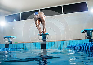 Swimmer standing on starting block