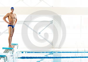 Swimmer standing on starting block