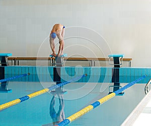 Swimmer standing on starting block