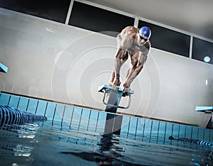 Swimmer standing on starting block