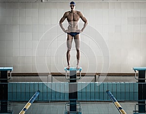 Swimmer standing on starting block