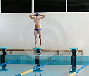 Swimmer standing on starting block