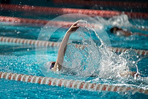 Swimmer swims backstroke swimming style in the pool