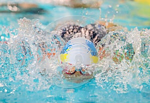 A swimmer swims in a pool