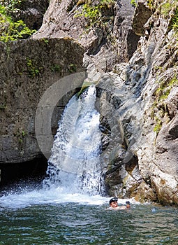 Swimmer taking selfie in water, Iadolina waterfall